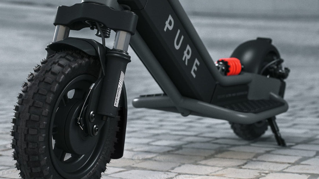 Close-up of the front tyre and fork on a Pure Escape Ultra Max Suspension electric scooter