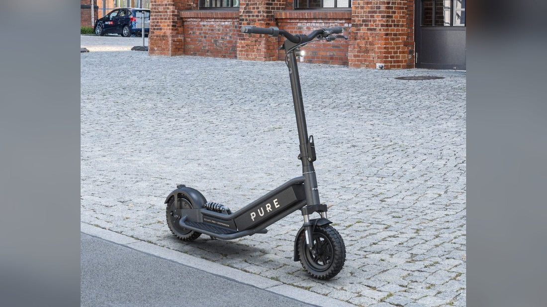 Pure Escape Pro+ Suspension electric scooter on a cobbled street
