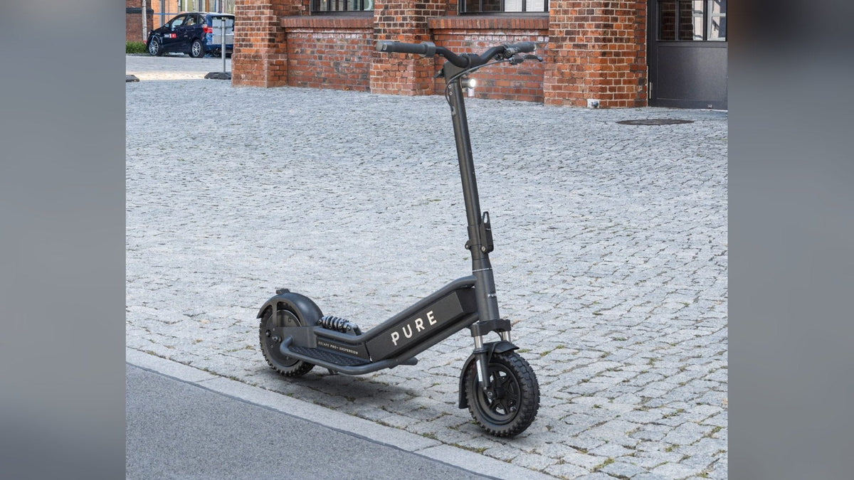 Pure Escape Pro+ Suspension electric scooter on a cobbled street